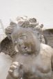 Coppia di statue di putti in stile antico da appendere