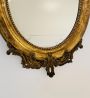 Antique 19th century oval mirror in gold leaf