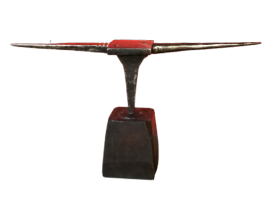 Antique double horn anvil with thin points, on a wooden block  