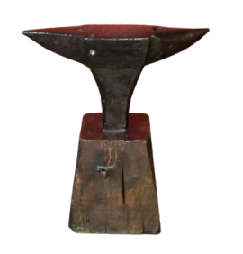 Antique double horn anvil on wooden block