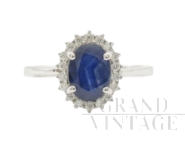 Gold ring with oval sapphire and diamonds