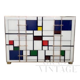 Mondrian style colored glass chest of drawers with four drawers