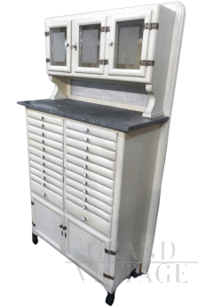 Vintage high cupboard in white wood with small drawers and marble top