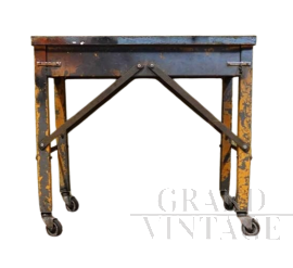 Industrial metal workshop table with wheels