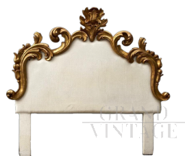 Antique bed headboard upholstered in white fabric and carved with gold leaf                         
                            