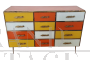 Dresser with 12 drawers in yellow and orange colored glass
