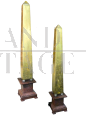 Pair of gilded wooden obelisks with porphyry effect base