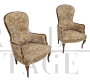 Pair of vintage wooden armchairs covered with floral fabric