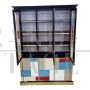 Large bookcase covered in colored glass and illuminated