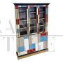 Large bookcase covered in colored glass and illuminated