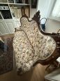 Antique carved sofa in floral fabric
