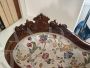 Antique carved sofa in floral fabric                            