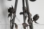 Antique wrought iron plant stand decorated with roses