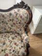 Antique carved sofa in floral fabric                            