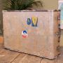 Vintage riveted beige fabric suitcase with stickers