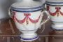 Pair of 18th century glazed terracotta spice jars with festoons