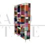 Open bookcase in wood covered in colored glass