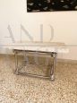 Coffee table in chromed rod with top in travertine marble                        
                            