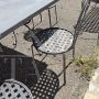 Garden set with 6 chairs and a large wrought iron table
