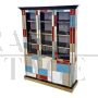 Large bookcase covered in colored glass and illuminated