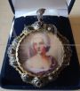 Liberty pendant or brooch in gold, silver and rubies with portrait of a lady