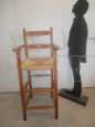 Vintage high chair with straw seat and armrests