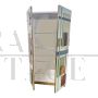 Wardrobe or pantry cabinet in colored glass with illuminated mirror interior