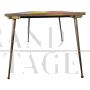 Design table in brass and color block glass