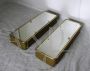 Pair of golden bathroom wall cabinets with mirror surface                            