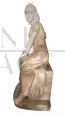Marble sculpture depicting a young woman sitting