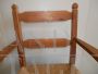 Vintage high chair with straw seat and armrests