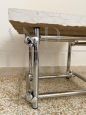 Coffee table in chromed rod with top in travertine marble