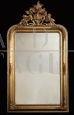 Antique vertical mirror in gilded and carved wood, 19th century