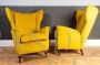 Pair of ISA armchairs covered in ocher yellow velvet