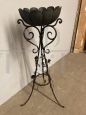 Antique wrought iron plant stand decorated with roses