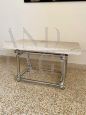 Coffee table in chromed rod with top in travertine marble