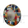 Large round mirror in multicolored glass