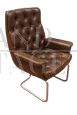 Directional vintage armchair in capitonné leather                       
                            