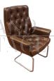 Directional vintage armchair in capitonné leather