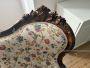 Antique carved sofa in floral fabric                            