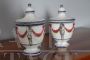 Pair of 18th century glazed terracotta spice jars with festoons