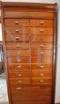Vintage wooden filing cabinet with drawers and roller shutter at the base