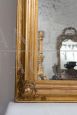 Antique Louis Philippe mirror in gilded and carved wood