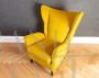 Pair of ISA armchairs covered in ocher yellow velvet