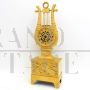 Antique Parisian Empire lyre clock in gilded bronze from the 19th century 
