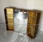 Pair of golden bathroom wall cabinets with mirror surface