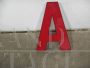 Vintage red plastic letter A from a 1970s sign