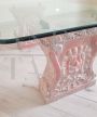 Vintage low coffee table with sculpted pink granite legs and glass top