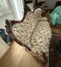 Antique carved sofa in floral fabric