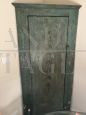   Antique Italian corner cabinet from the 17th century in green paint                          